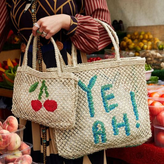 THE JACKSONS LONDON JUTE BAG . CHERRYS. IN NATURAL WITH RASPBERRY, GREEN